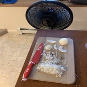 chop onions in front of the kitchen fan/vent