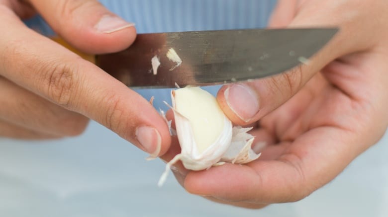 peeling garlic using knife