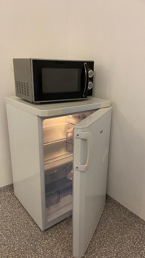 is placing a microwave on top of a Mini - fridge safe